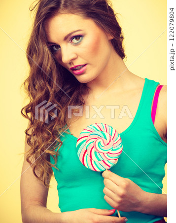 Woman charming girl with lollipop candy 122079804
