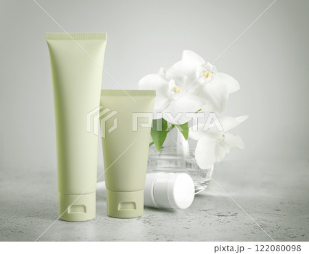 Green tubes standing on green background, offering blank space for branding of skincare or cosmetic product. Template for design, mockup. Natural Beauty concept Green tubes standing on green background, offering blank space for branding of skincare or cosmetic product. Template for design, mockup. Natural Beauty concept 122080098
