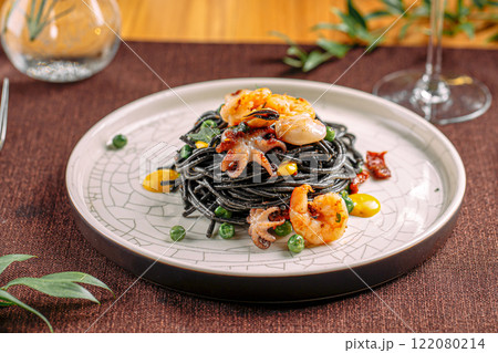 Portion of gourmet black pasta with seafood 122080214