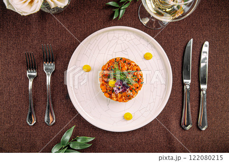 Portion of salmon tartare with chopped avocado 122080215