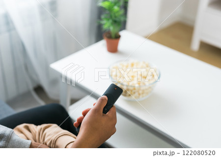 Remote control is pointed toward the television screen, control and choice of tv entertainment. TV, series and streaming service concept 122080520