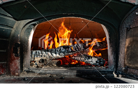 Fire inside a stone oven. 122080723