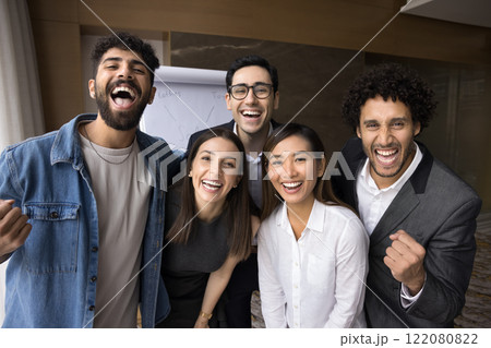 Group of five happy multiracial staff members celebrate business achievements Group of five happy multiracial staff members celebrate business achievements 122080822