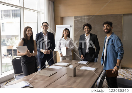 Portrait of five multinational professionals posing in modern office 122080840