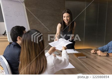 Boss gives contract papers for learning before signing during negotiations 122080854