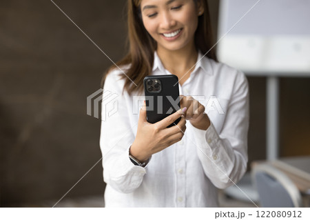Close up pretty Asian woman using smartphone in office 122080912
