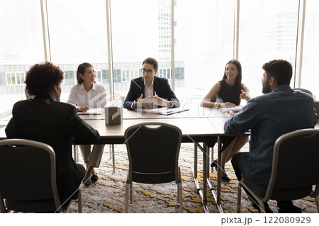 Young Arabian businessman dressed in suit speaking with colleagues Young Arabian businessman dressed in suit speaking with colleagues 122080929