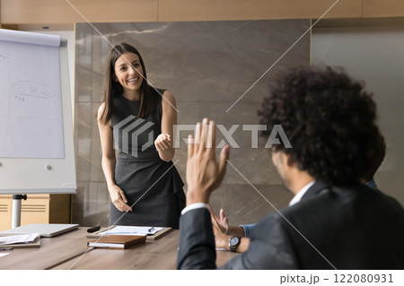 Businessman in suit raising hand at corporate diverse group meeting Businessman in suit raising hand at corporate diverse group meeting 122080931