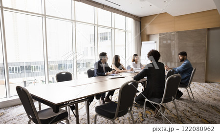 Group of diverse business partners negotiating in modern meeting room Group of diverse business partners negotiating in modern meeting room 122080962