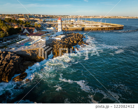 Aerial view of Santa Marta lighthouse and Cascais marina with Cascais cityscape Aerial view of Santa Marta lighthouse and Cascais marina with Cascais cityscape 122082412