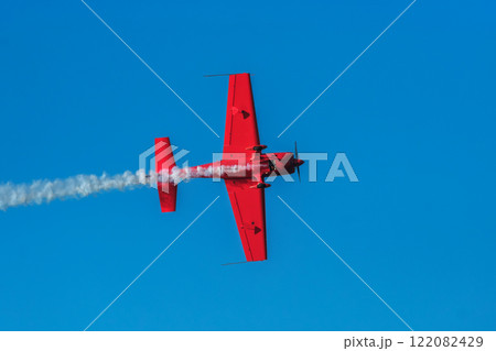 Stunt aerobatic plane performing stunts in air 122082429