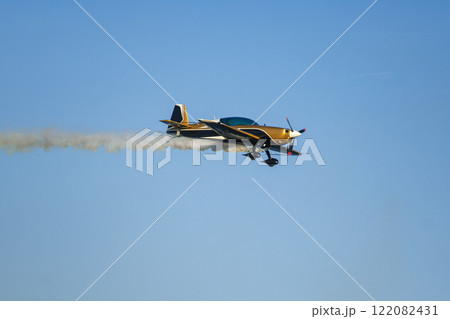 Stunt aerobatic plane performing stunts in air 122082431