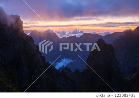 Mountains on sunset covered in fog and clouds. Madeira island, Portugal Mountains on sunset covered in fog and clouds. Madeira island, Portugal 122082435