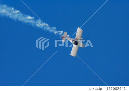 Stunt aerobatic plane performing stunts in air 122082441