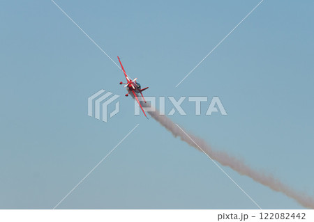 Stunt aerobatic plane performing stunts in air 122082442