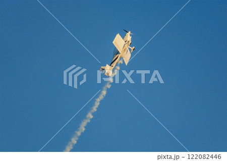 Stunt aerobatic plane performing stunts in air 122082446