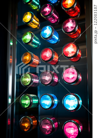 A close-up of a colorful, modern control panel featuring many colorful buttons. Rows of electronic, luminous round buttons, operating machinery and appliances in an industrial setting. AI-generated 122083187