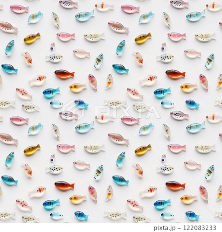 Colorful glass fish scattered on white creating fun background. Many shiny little fish shaped decorative elements, flat lay. AI-generated 122083233