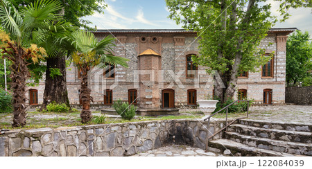 Imam Ali Mosque, a historical mosque stands in a courtyard surrounded by greenery, Shaki, Azerbaijan 122084039