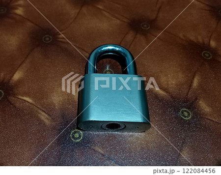 Metal Padlock on the table. Security concept Metal Padlock on the table. Security concept 122084456