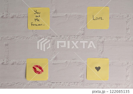 Four yellow sticker papers with lipstick kiss mark, inscription "Love you!", "You and me forever" and small black heart on white brick wall background. Romantic message for Valentine's Day Four yellow sticker papers with lipstick kiss mark, inscription "Love you!", "You and me forever" and small black heart on white brick wall background. Romantic message for Valentine's Day 122085135