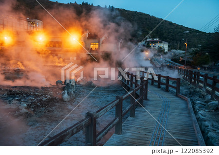 Mount Unzen Jigoku with heavy sulfur gas and ryokan at night 122085392