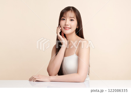Beautiful young asian woman with clean fresh skin on beige background, Face care, Facial treatment, Cosmetology, beauty and spa, Asian women portrait. 122086335