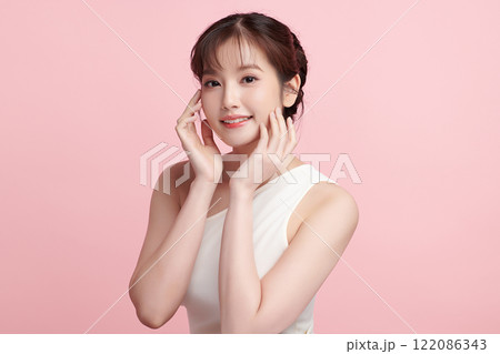 Beautiful young asian woman with clean fresh skin on pink background, Face care, Facial treatment, Cosmetology, beauty and spa, Asian women portrait. Beautiful young asian woman with clean fresh skin on pink background, Face care, Facial treatment, Cosmetology, beauty and spa, Asian women portrait. 122086343
