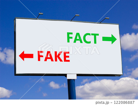 Fact or fake symbol. Concept word Fake and Fact on beautiful billboard with two arrows. Beautiful blue sky with clouds background. Business and fact or fake concept. Copy space. Fact or fake symbol. Concept word Fake and Fact on beautiful billboard with two arrows. Beautiful blue sky with clouds background. Business and fact or fake concept. Copy space. 122086887