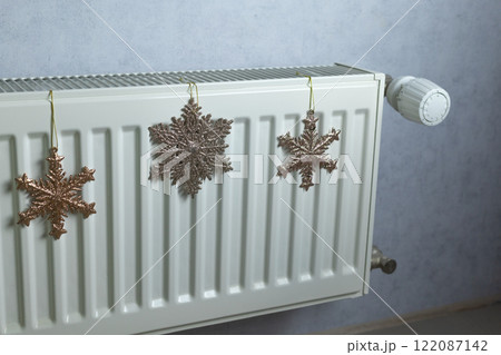 snowflakes on a radiator in a room of an apartment building 122087142