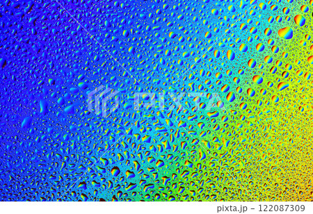 Vibrant droplets of water create a colorful abstract masterpiece on glass surface Vibrant droplets of water create a colorful abstract masterpiece on glass surface 122087309