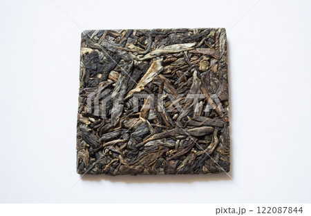 Pressed shen puerh on a white background Pressed shen puerh on a white background 122087844