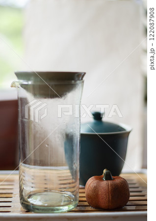 Tea glass and ceramic teapot on the wooden tea table. Tea ceremony Tea glass and ceramic teapot on the wooden tea table. Tea ceremony 122087908
