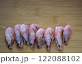 Shrimps on wooden cutting board 122088102
