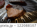 Beef steak on a barbecue grill, close up 122088107
