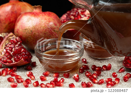 Natural Pomegranate Vinegar Pour From Cruet Into Glass Bowl 122088487