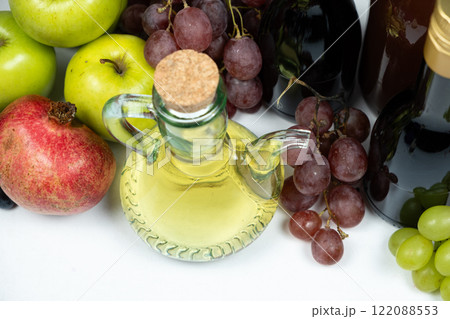 Various fruit vinegars on the background of fruits 122088553