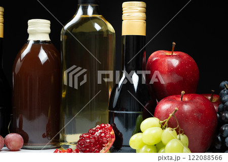Different types of vinegar. Pomegranate, apple and balsamic vinegars in bottles Different types of vinegar. Pomegranate, apple and balsamic vinegars in bottles 122088566