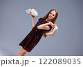 A Fashionable Young Girl, wearing High Heels, joyfully holding gifts in her hands 122089035