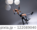 A Playful Child Enjoying Balloons in a Bright and Colorful Studio Setting Full of Life 122089040