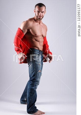 Handsome muscular man posing in studio on gray background 122091177