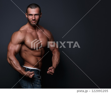 Portrait of handsome muscular man posing in studio Portrait of handsome muscular man posing in studio 122091205