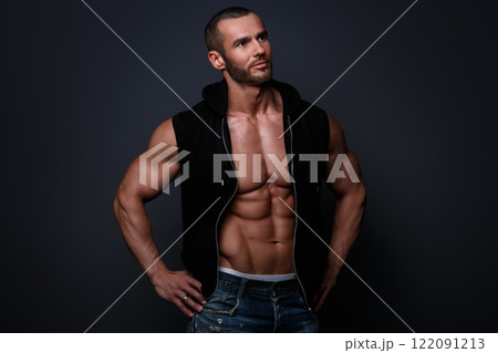 Portrait of handsome muscular man posing in studio Portrait of handsome muscular man posing in studio 122091213