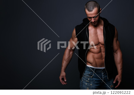 Portrait of handsome muscular man posing in studio Portrait of handsome muscular man posing in studio 122091222