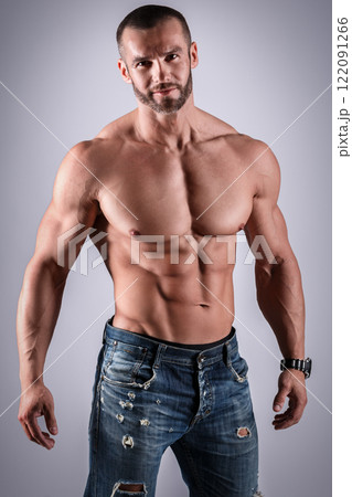 Handsome muscular man wearing jeans posing in studio 122091266