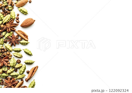 Colorful spices creating a vertical border on white background Colorful spices creating a vertical border on white background 122092324