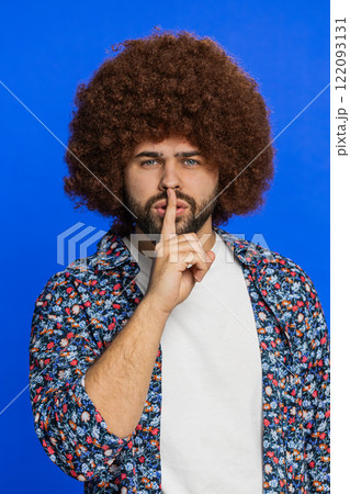 Young man presses finger to lips make silence gesture sign do not tells secret stop gossip privacy 122093131