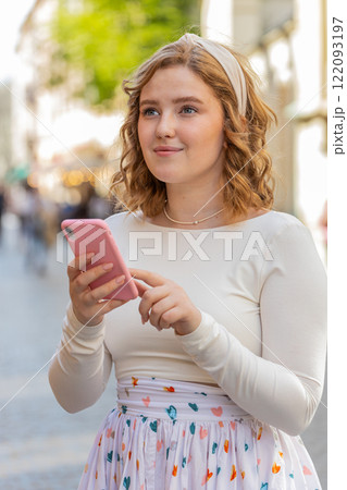 Young woman using smartphone typing text messages looking for a way on map in mobile navigator app 122093197