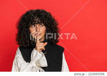 Young woman presses finger to lips make silence gesture sign do not tells secret stop gossip privacy 122093200