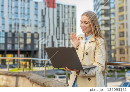 Happy mature businesswoman employer on video call using laptop netbook in downtown city street Happy mature businesswoman employer on video call using laptop netbook in downtown city street 122093381